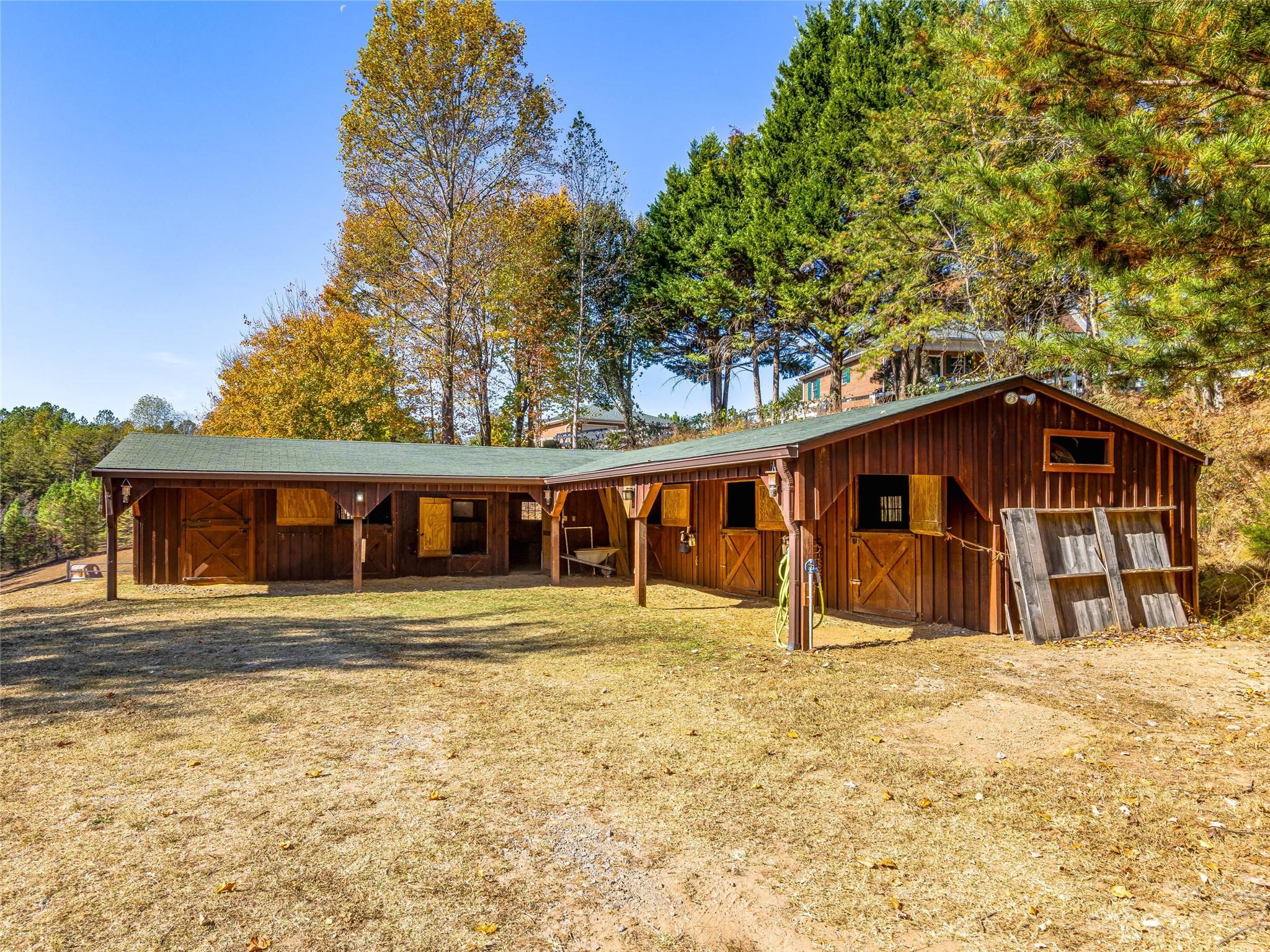 263 Sylvan Lane Mill Spring, NC 28756 - Photo 35 of 45 a house with trees in front of it