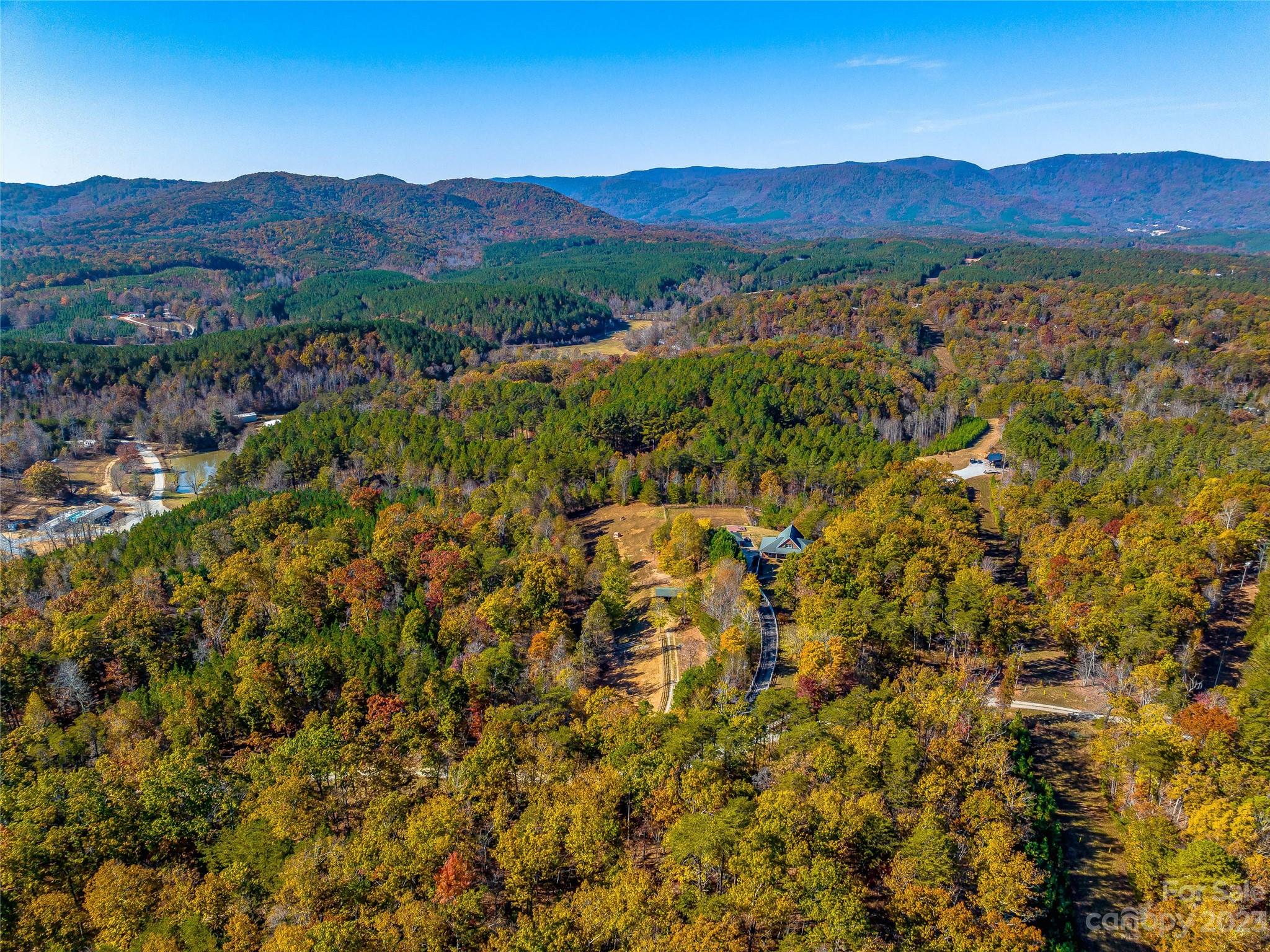 263 Sylvan Lane Mill Spring, NC 28756 - Photo 44 of 45 a view of a lush green hillside and houses
