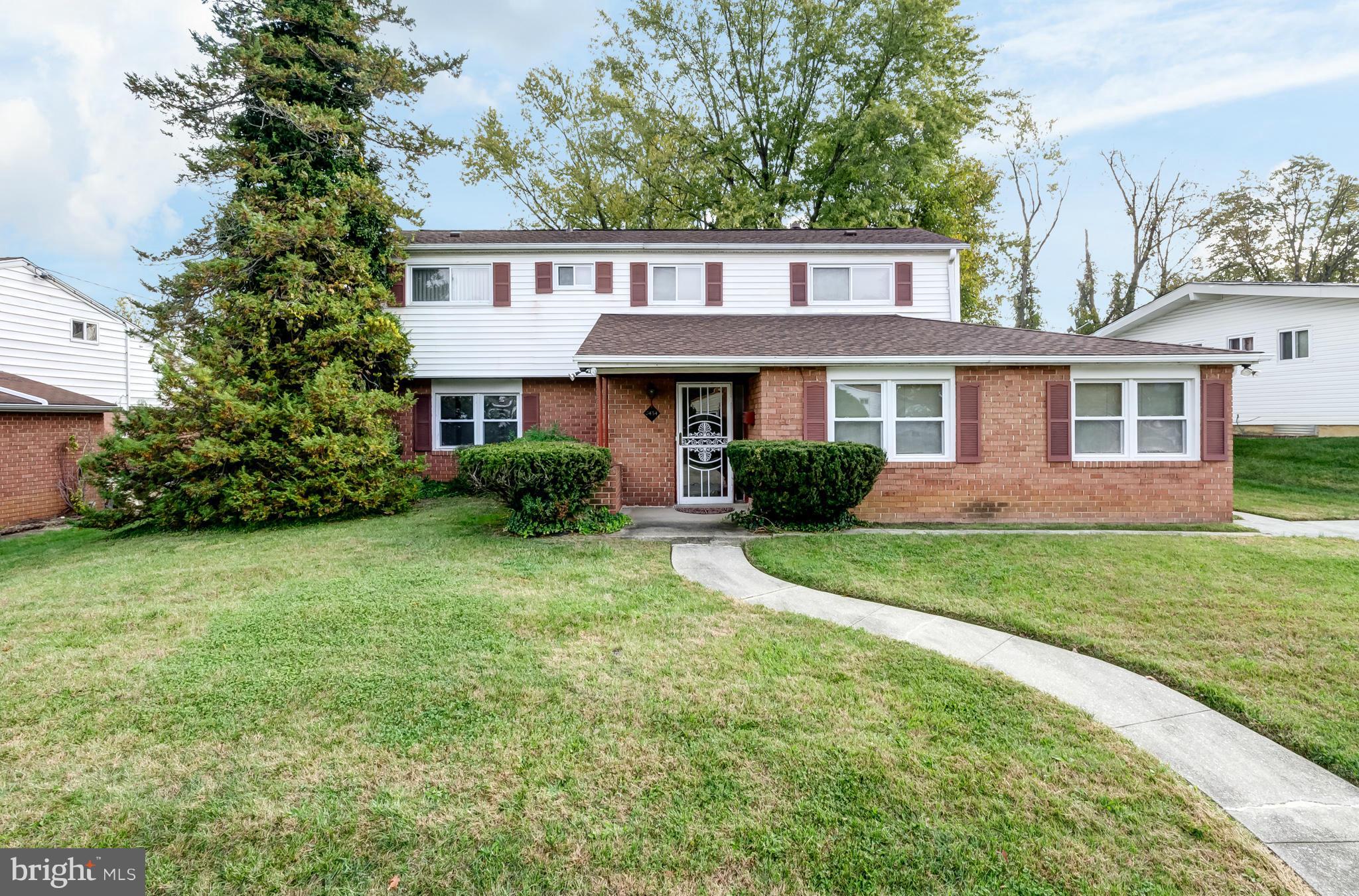 7434 Ricksway Road Pikesville, MD 21208 - Photo 1 of 30 a front view of a house with a yard and trees