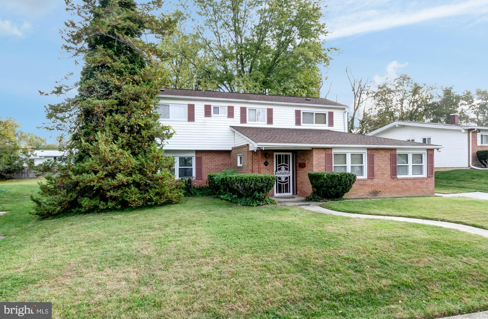 7434 Ricksway Road Pikesville, MD 21208 - Photo 2 of 30 a front view of a house with a yard and garage
