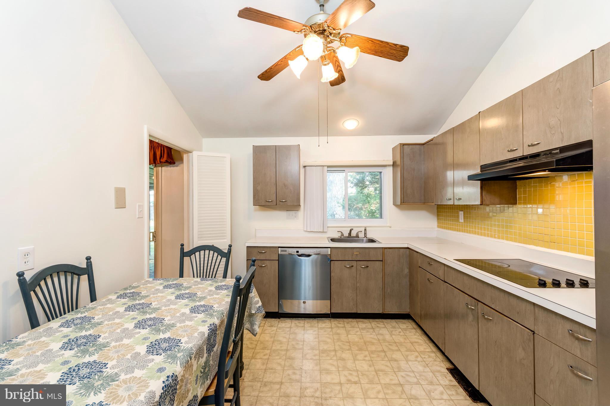 7434 Ricksway Road Pikesville, MD 21208 - Photo 17 of 30 a large kitchen with a large window and stainless steel appliances