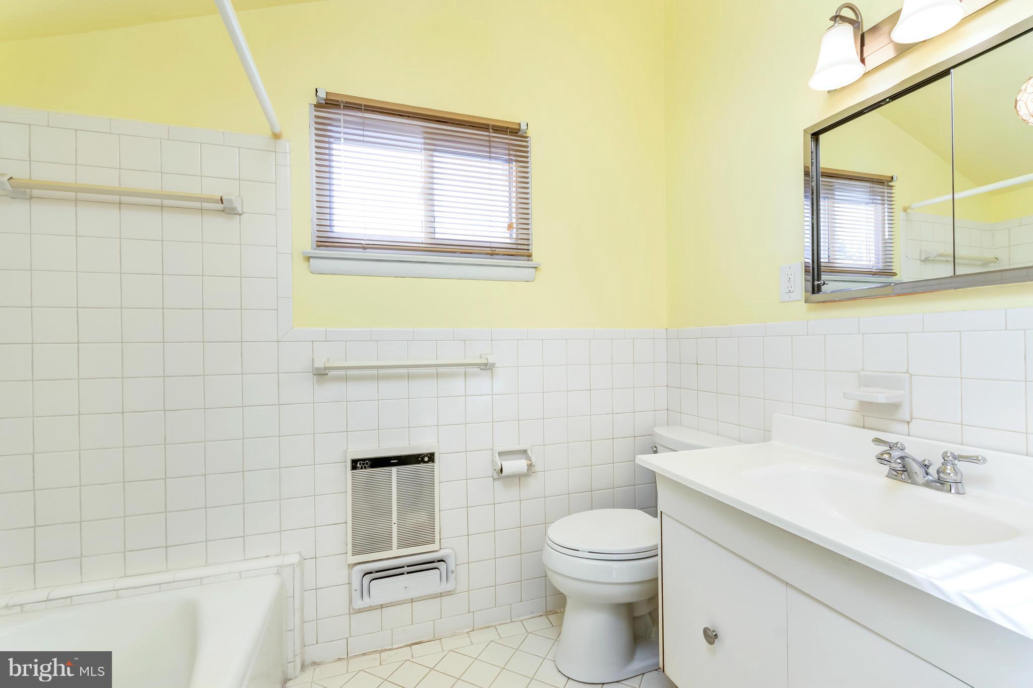 7434 Ricksway Road Pikesville, MD 21208 - Photo 18 of 30 a bathroom with a sink a toilet and mirror