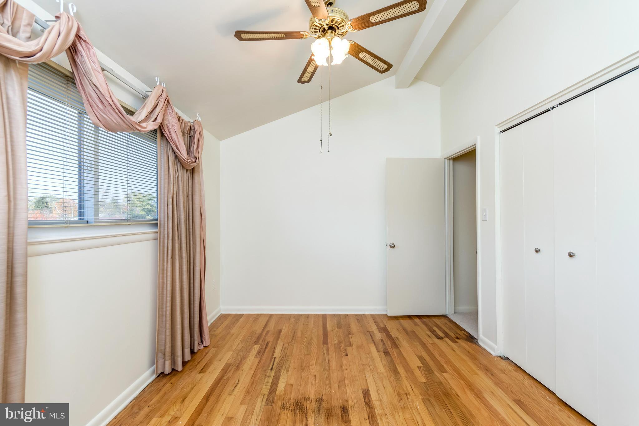 7434 Ricksway Road Pikesville, MD 21208 - Photo 20 of 30 a view of a room with wooden floor closet and a ceiling fan