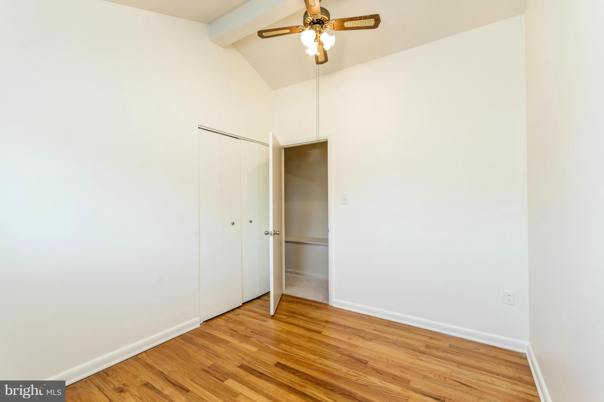 7434 Ricksway Road Pikesville, MD 21208 - Photo 22 of 30 a view of an empty room with wooden floor
