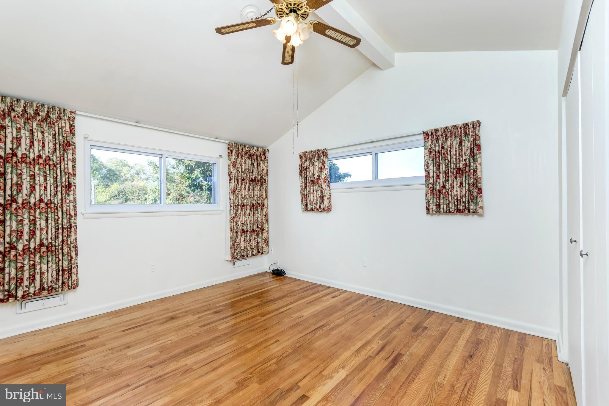 7434 Ricksway Road Pikesville, MD 21208 - Photo 23 of 30 a view of empty room with wooden floor and fan
