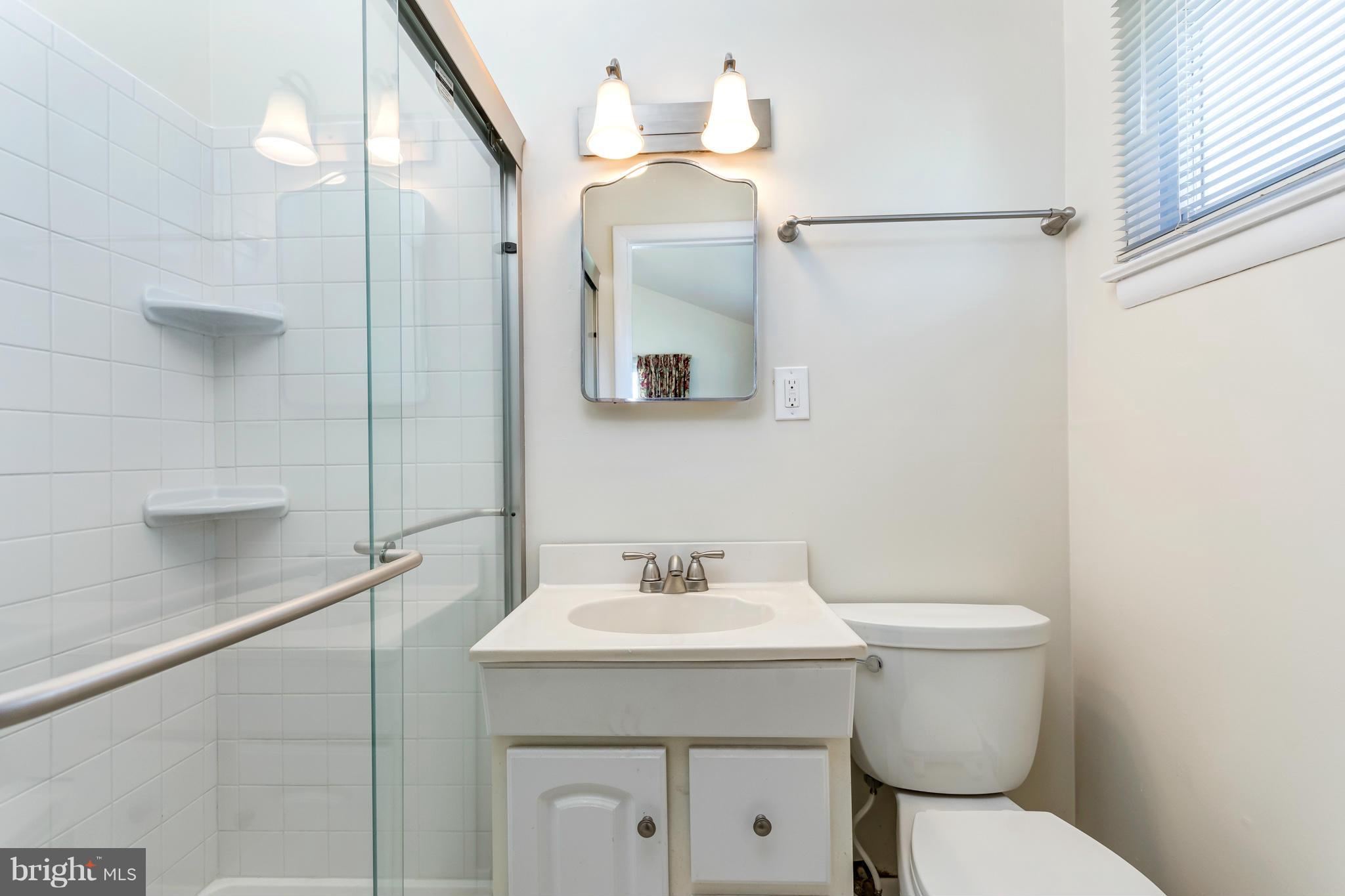 7434 Ricksway Road Pikesville, MD 21208 - Photo 25 of 30 a bathroom with a toilet sink and mirror
