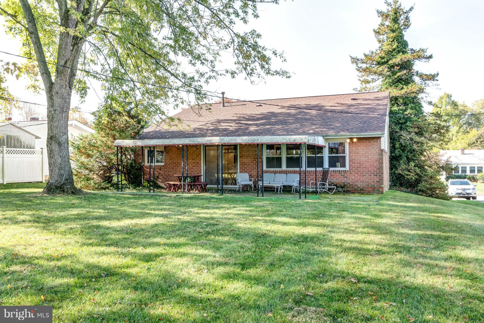 7434 Ricksway Road Pikesville, MD 21208 - Photo 27 of 30 a front view of a house with a garden