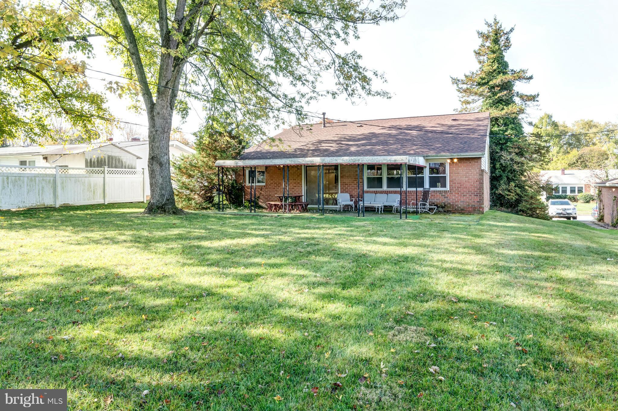 7434 Ricksway Road Pikesville, MD 21208 - Photo 28 of 30 a view of a house with a yard and trees