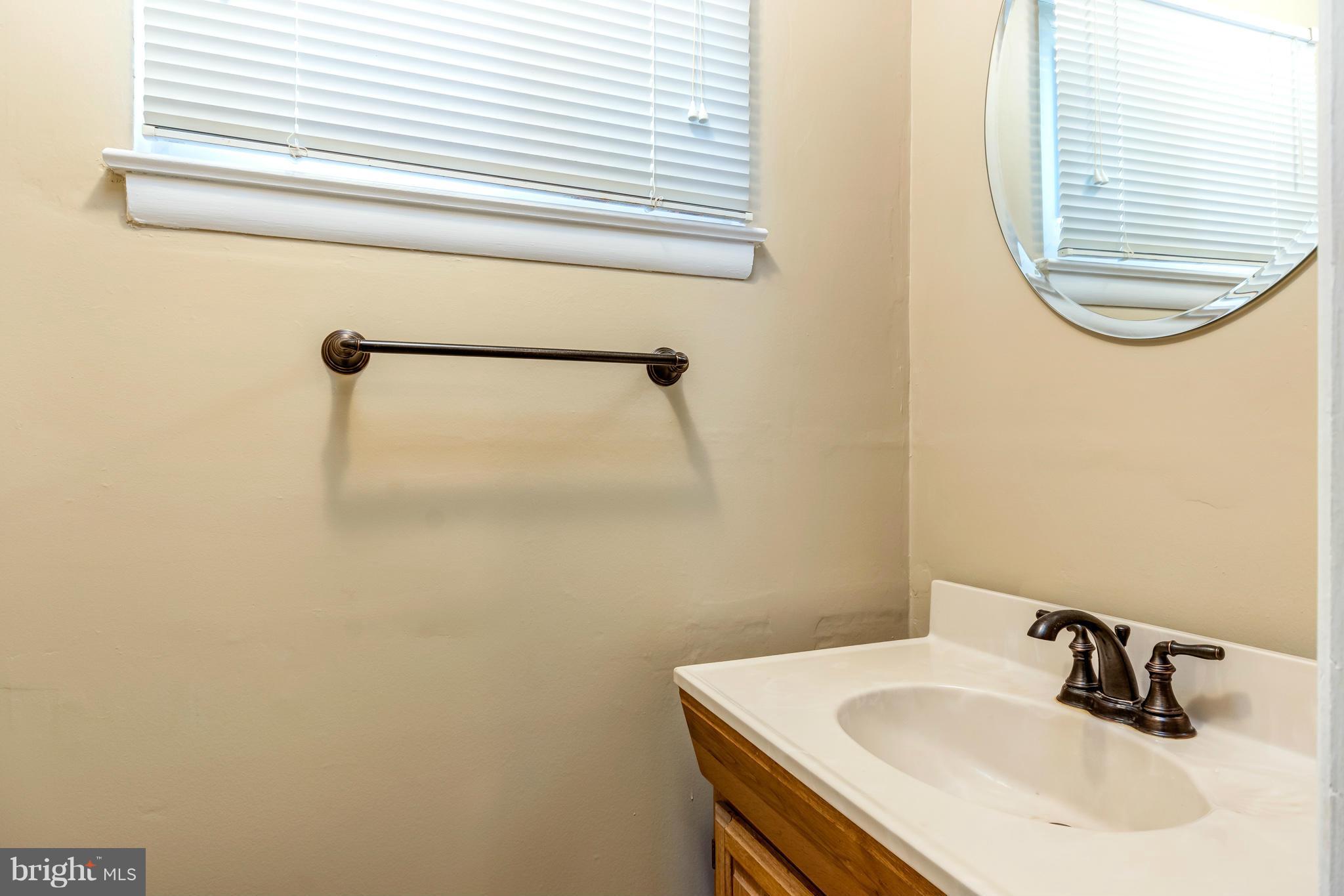 7434 Ricksway Road Pikesville, MD 21208 - Photo 9 of 30 a bathroom with a sink and a mirror