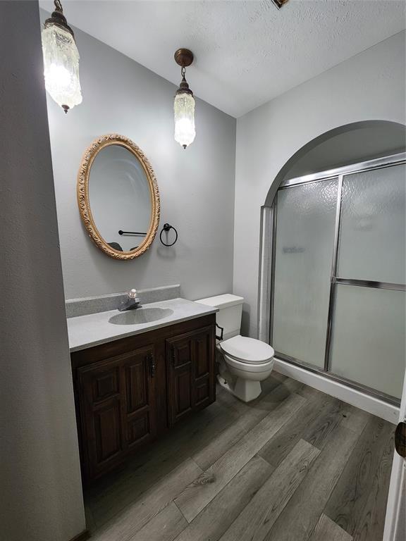 5604 Usher Street The Colony, TX 75056 - Photo 21 of 30 a bathroom with a toilet a sink and a mirror