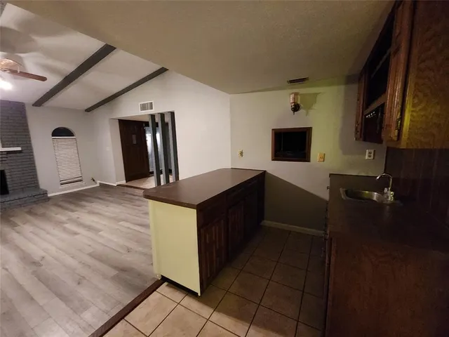 a view of a room with wooden floor and white walls
