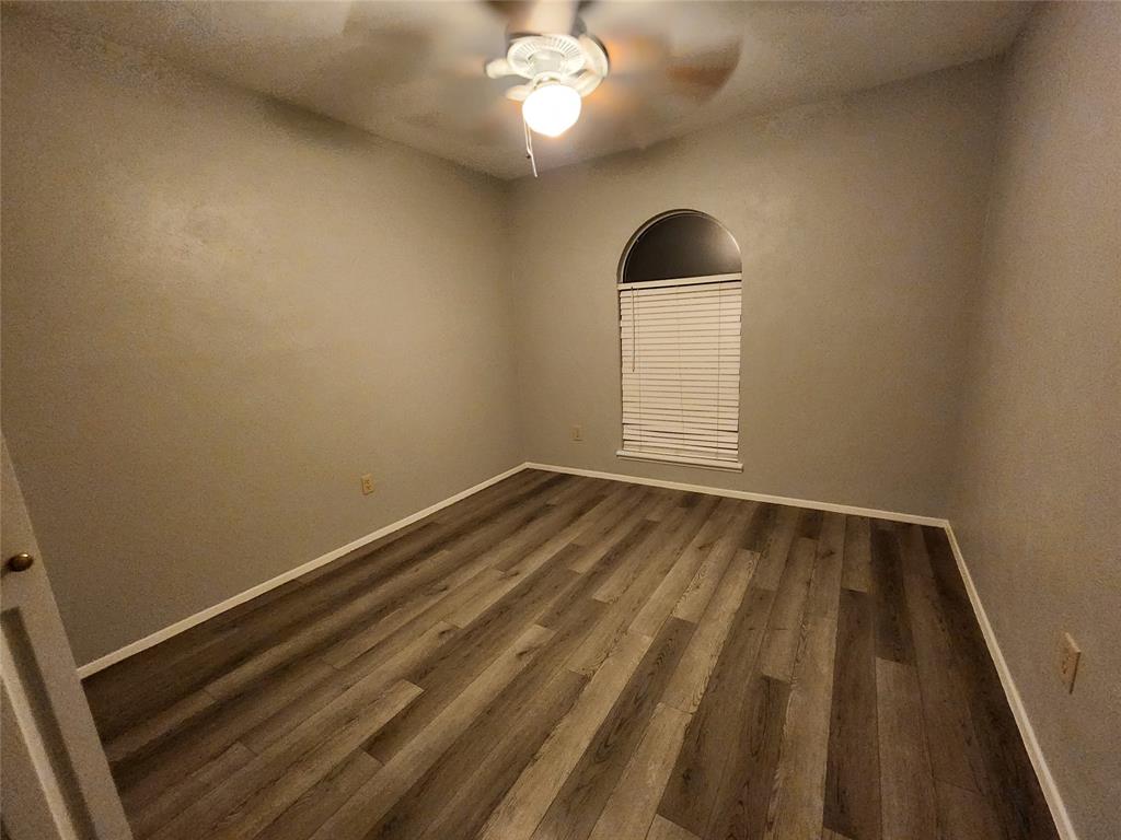 5604 Usher Street The Colony, TX 75056 - Photo 26 of 30 a view of a room with wooden floor and white walls
