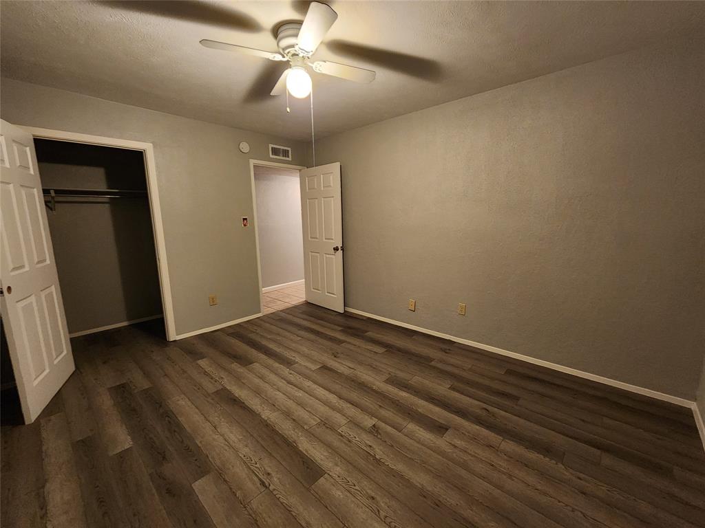 5604 Usher Street The Colony, TX 75056 - Photo 29 of 30 an empty room with wooden floor closet and fan