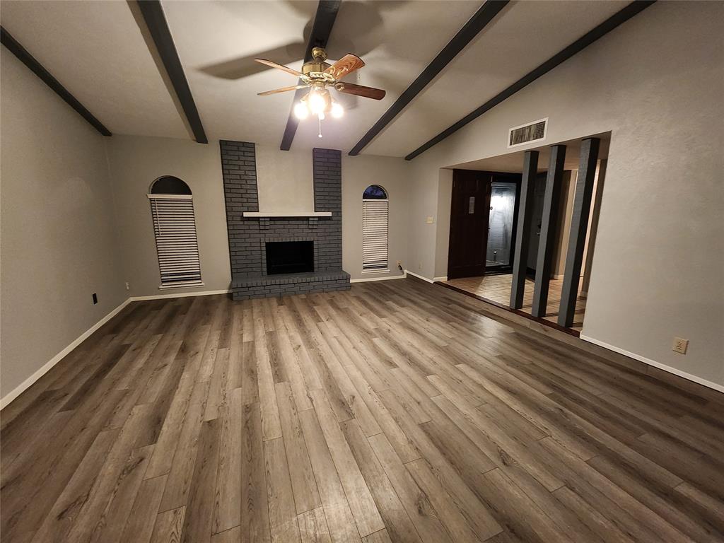 5604 Usher Street The Colony, TX 75056 - Photo 5 of 30 wooden floor in an empty room with a fireplace