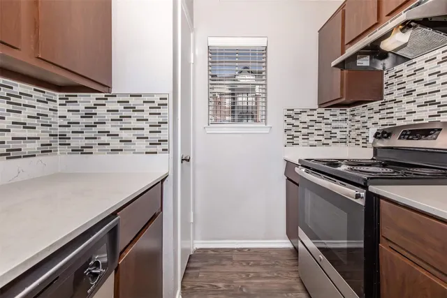 a kitchen with a stove and a cabinets