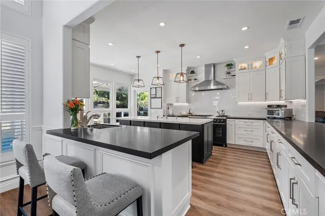 a kitchen with stainless steel appliances a refrigerator sink and cabinets