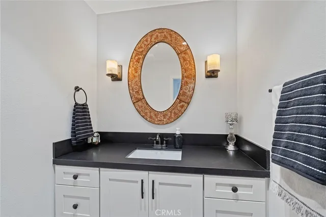 a large bathroom with a tub a sink and mirror