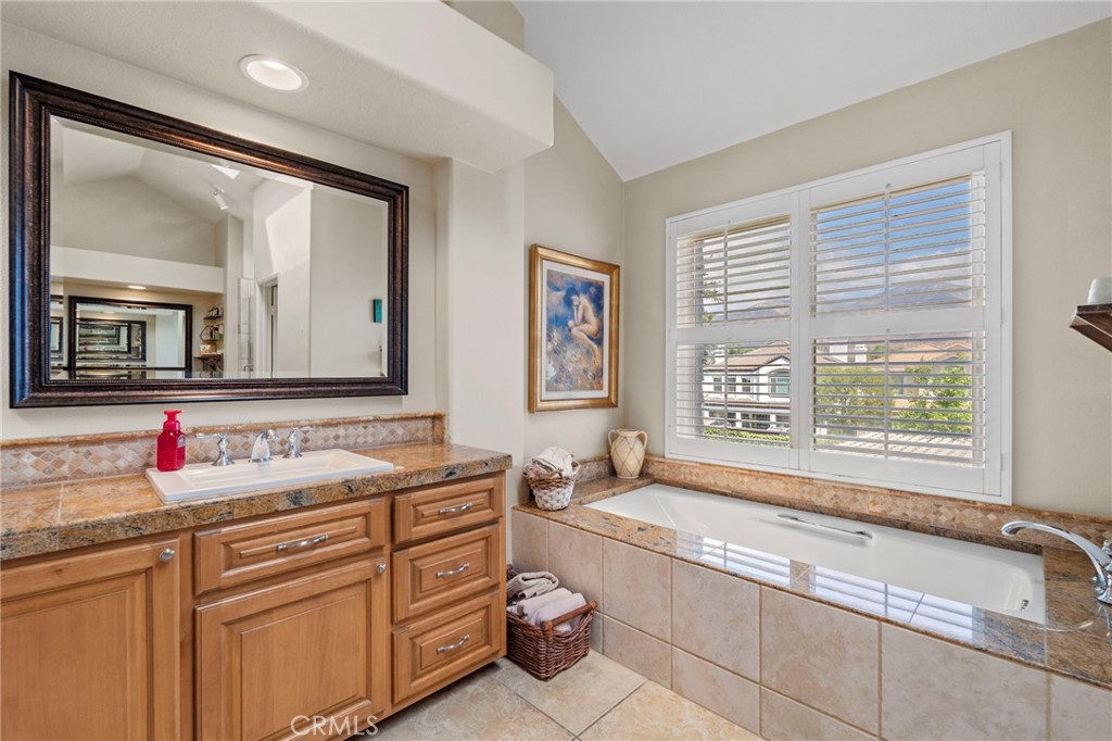 3 Snowdon Rancho Santa Margarita, CA 92679 - Photo 23 of 69 a spacious bathroom with a granite countertop tub sink and mirror