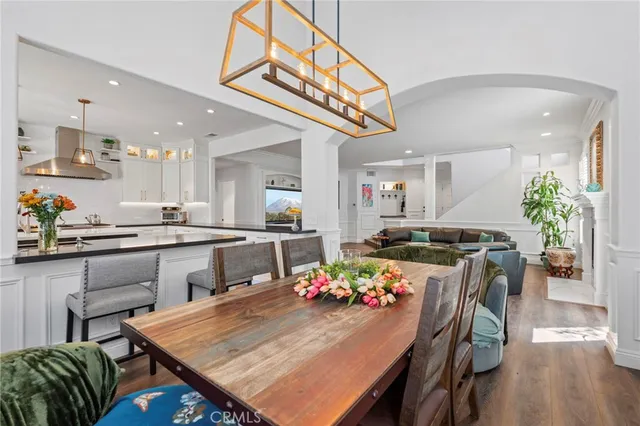 a kitchen with stainless steel appliances a stove and white cabinets