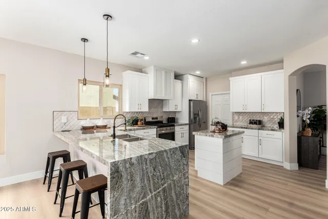 a kitchen with a sink stove and cabinets