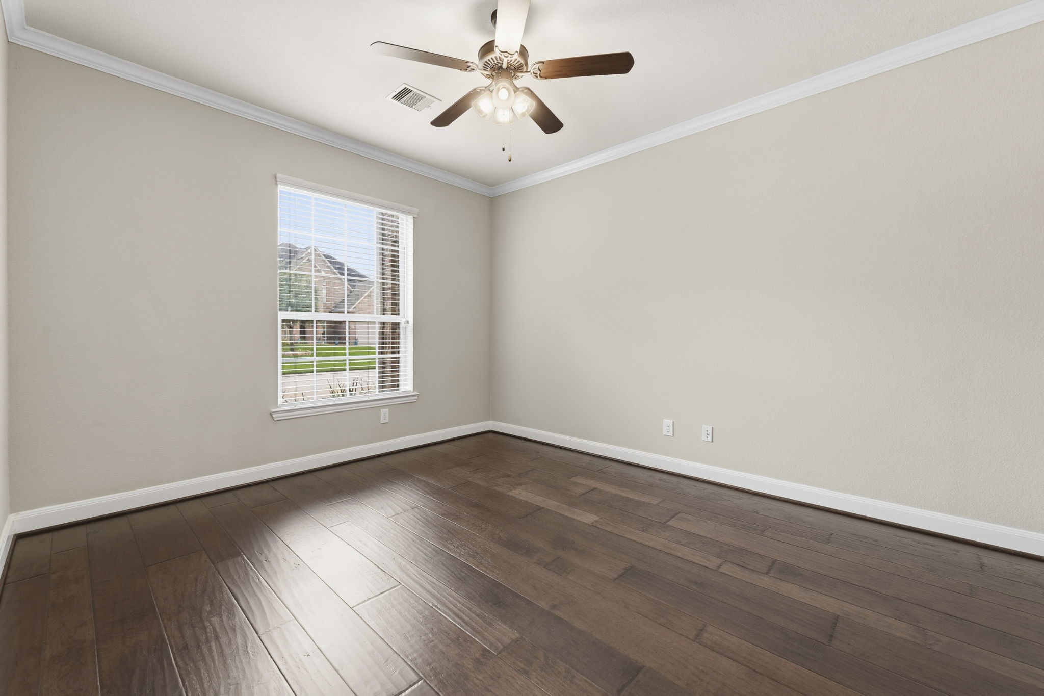 25210 Gaddis Oaks Drive Spring, TX 77389 - Photo 5 of 50 an empty room with wooden floor ceiling fan and windows