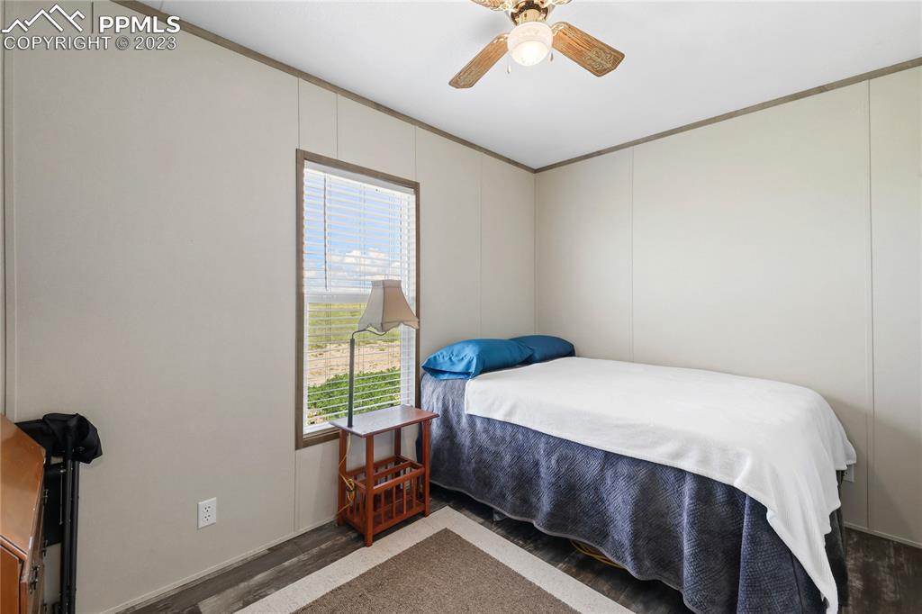 10845 Berridge Road Calhan, CO 80808 - Photo 13 of 32 a bedroom with a bed and a window