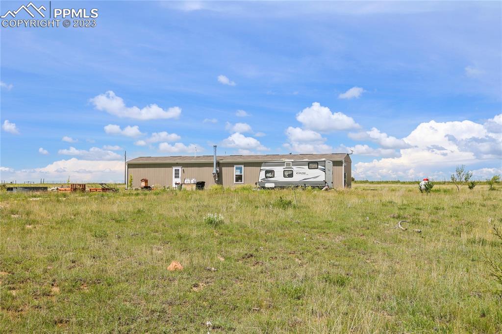 10845 Berridge Road Calhan, CO 80808 - Photo 21 of 32 a view of a big yard with an of palm trees
