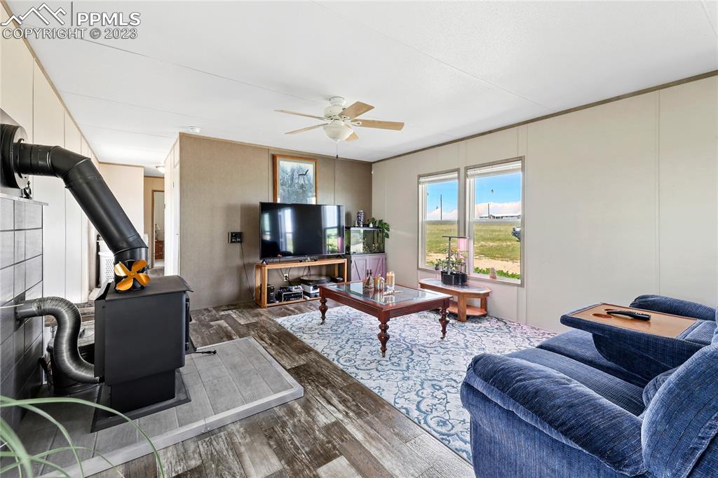 10845 Berridge Road Calhan, CO 80808 - Photo 3 of 32 a living room with furniture and a flat screen tv