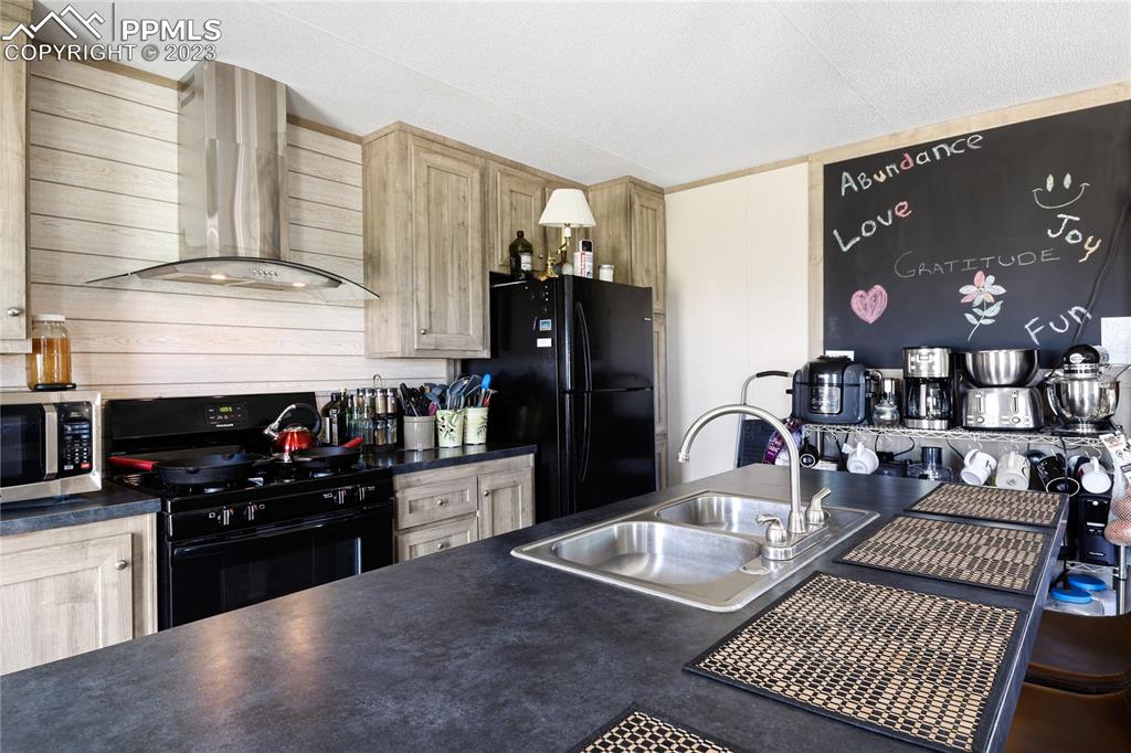 10845 Berridge Road Calhan, CO 80808 - Photo 6 of 32 a kitchen with granite countertop a stove and cabinets