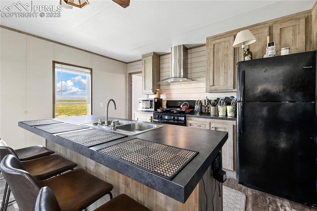 10845 Berridge Road Calhan, CO 80808 - Photo 9 of 32 a kitchen with a table chairs and a refrigerator