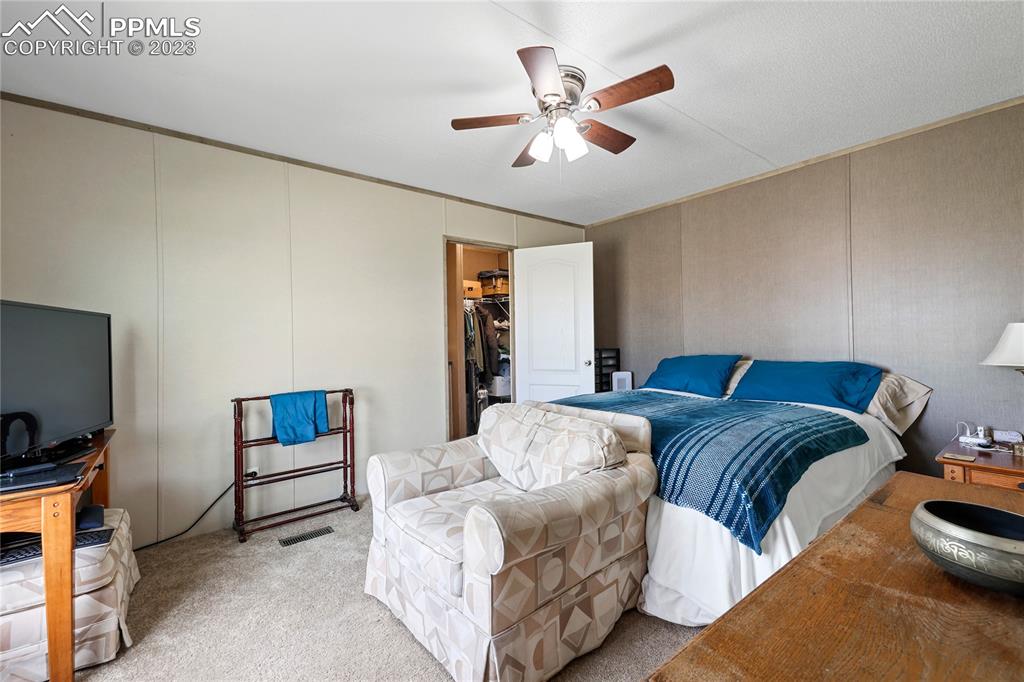 10845 Berridge Road Calhan, CO 80808 - Photo 10 of 32 a bedroom with furniture and a flat screen tv