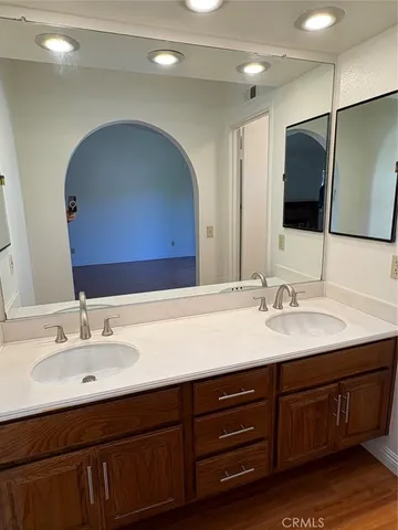 a bathroom with a double vanity sink and a mirror