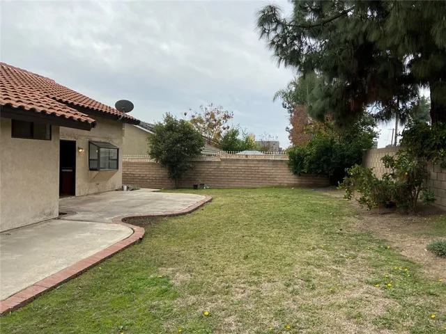 a view of a house with pool and a yard