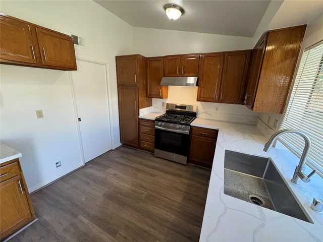 a kitchen with wooden cabinets and a sink