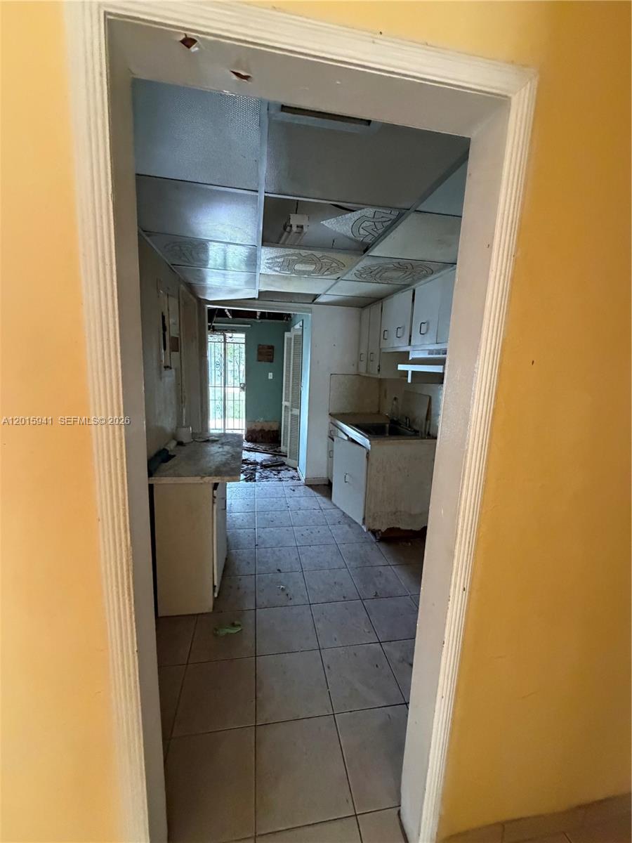841 Northeast 4th Place Hialeah, FL 33010 - Photo 3 of 6 a kitchen with a sink and a refrigerator