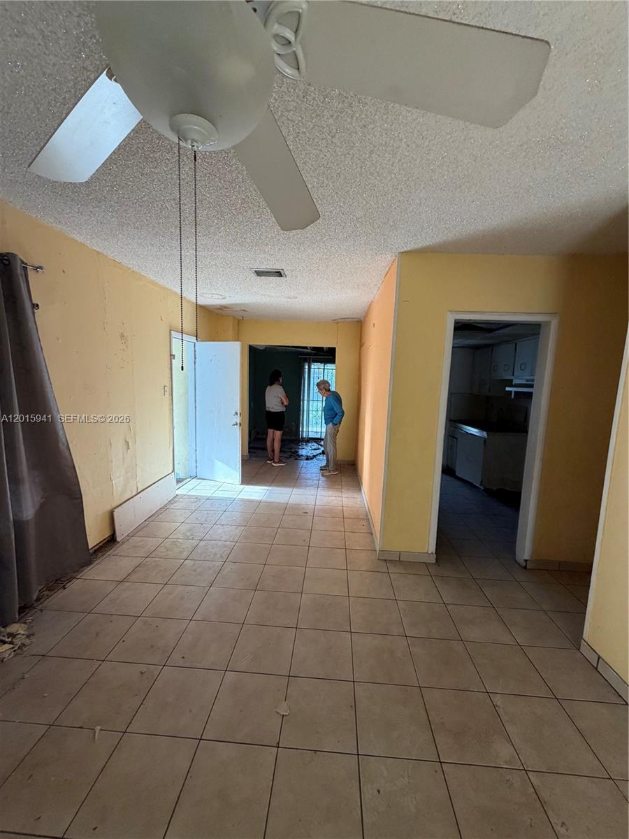 841 Northeast 4th Place Hialeah, FL 33010 - Photo 6 of 6 an empty room with fan and white walls