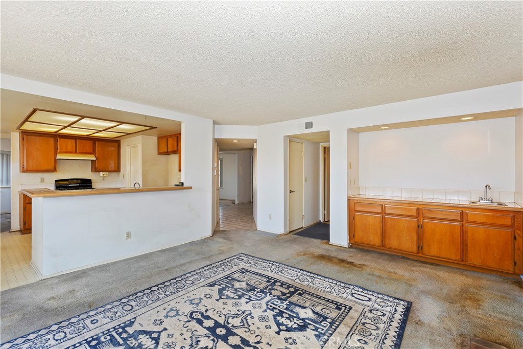 15620 Smoke Tree Street Hesperia, CA 92345 - Photo 11 of 34 a view of a kitchen with a sink cabinets and a window