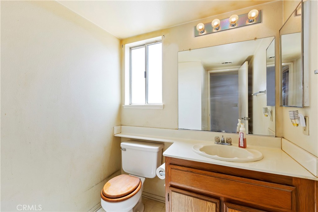 15620 Smoke Tree Street Hesperia, CA 92345 - Photo 16 of 34 a bathroom with a sink a toilet and a mirror