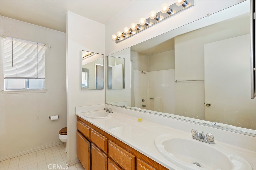 15620 Smoke Tree Street Hesperia, CA 92345 - Photo 19 of 34 a bathroom with a double vanity sink mirror and toilet