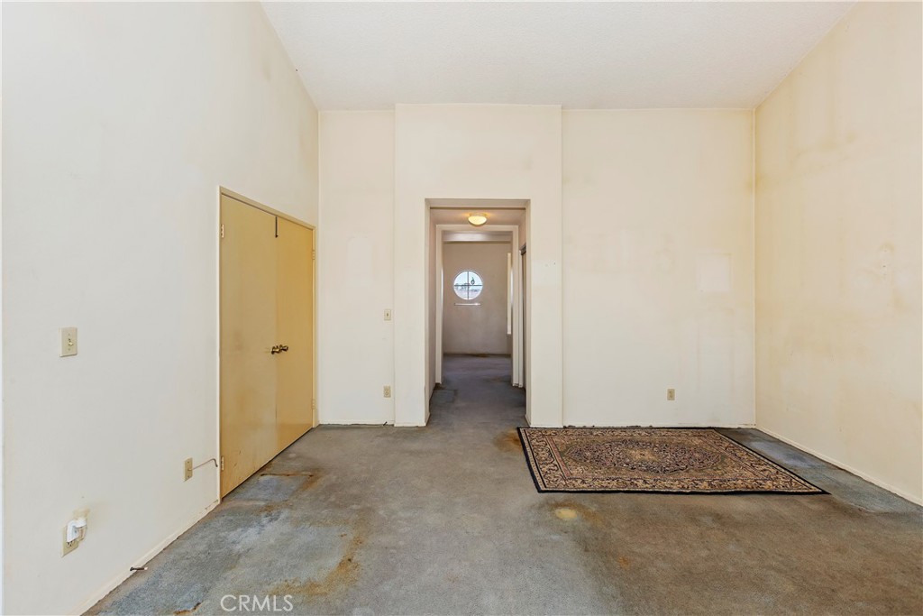 15620 Smoke Tree Street Hesperia, CA 92345 - Photo 21 of 34 an empty room with closet and window