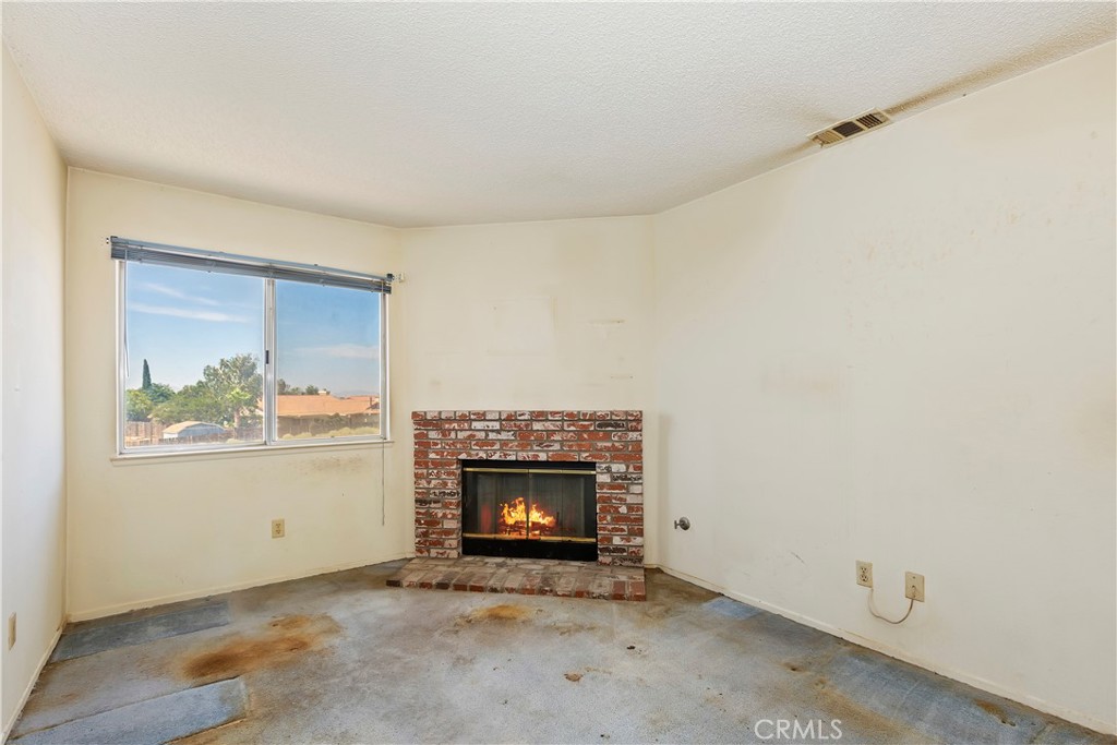15620 Smoke Tree Street Hesperia, CA 92345 - Photo 24 of 34 an empty room with windows and fireplace