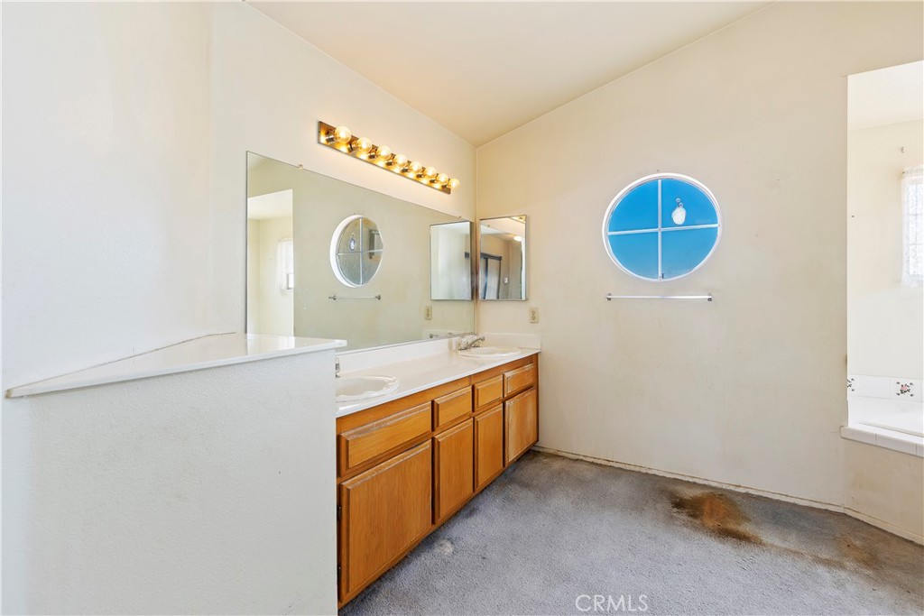 15620 Smoke Tree Street Hesperia, CA 92345 - Photo 26 of 34 a bathroom with a sink and a mirror