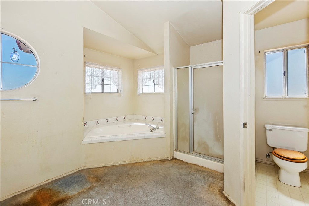 15620 Smoke Tree Street Hesperia, CA 92345 - Photo 27 of 34 a bathroom with a sink a toilet and shower