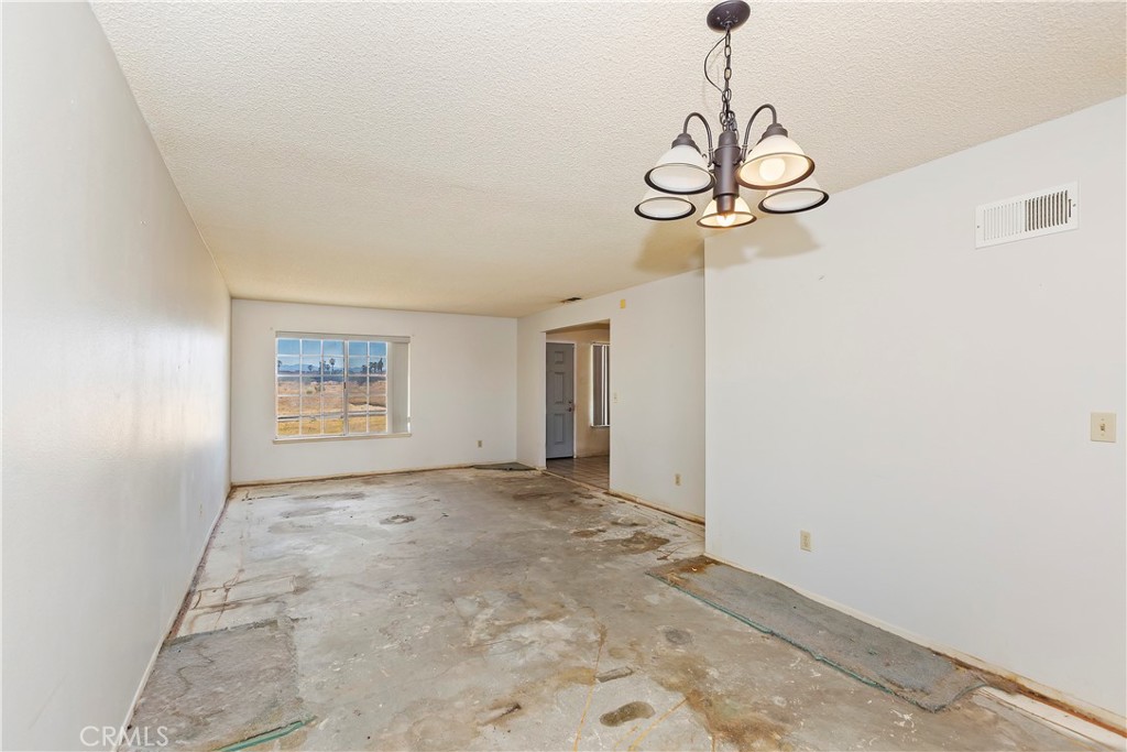 15620 Smoke Tree Street Hesperia, CA 92345 - Photo 6 of 34 a view of a hallway with a chandelier