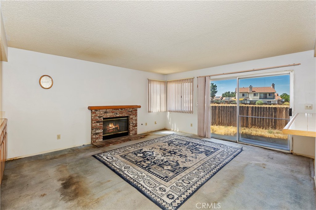 15620 Smoke Tree Street Hesperia, CA 92345 - Photo 9 of 34 a view of empty room with a fireplace