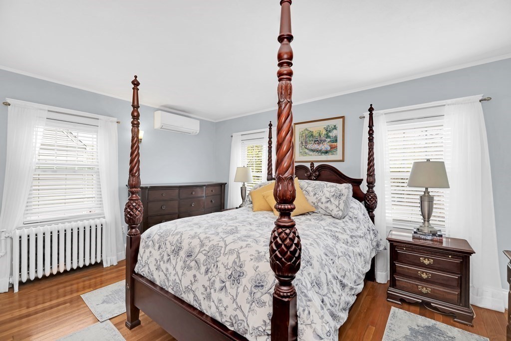 192 Maple Street Boston, MA 02132 - Photo 11 of 24 a bedroom with a bed and wooden floor