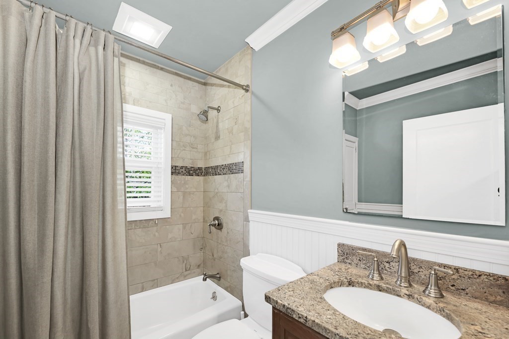 192 Maple Street Boston, MA 02132 - Photo 18 of 24 a bathroom with a granite countertop sink a mirror and a shower