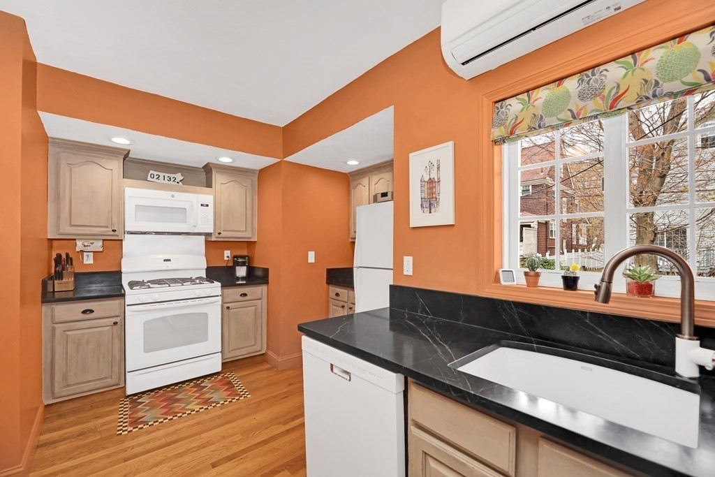 192 Maple Street Boston, MA 02132 - Photo 9 of 24 a kitchen with granite countertop a sink and a stove top oven