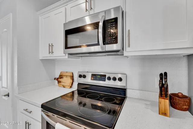 a kitchen with stainless steel appliances a sink a stove and refrigerator