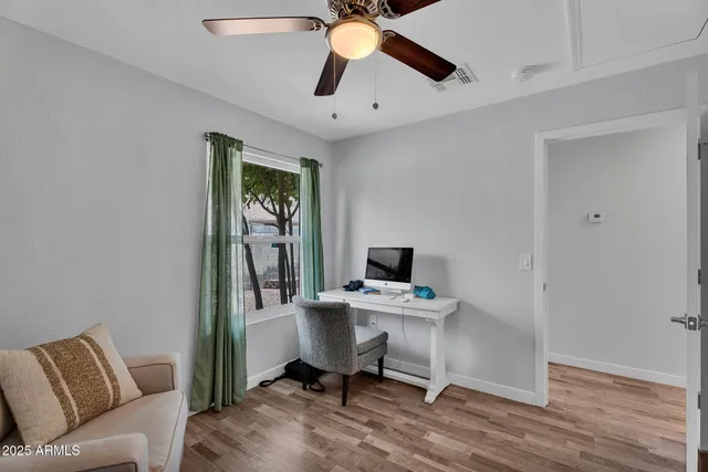 a view of a hallway with wooden floor and a floor to ceiling window